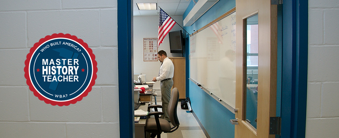 A picture of a classroom teacher with a badge A picture of a classroom teacher with a badge