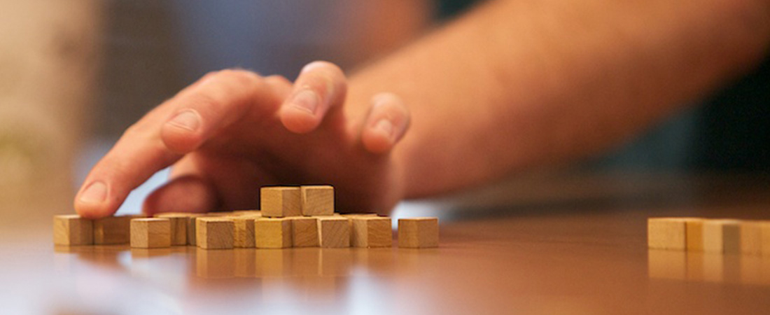 A picture of a child using blocks to solve a math problem.