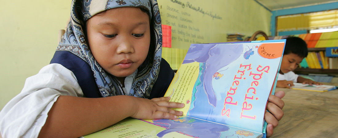 A child in the Philippines reading a book.