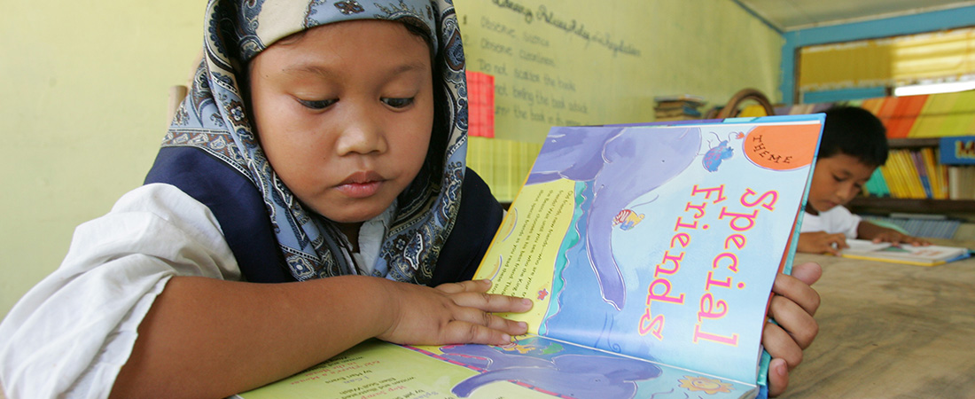 A child in the Philippines reading a book. A child in the Philippines reading a book.