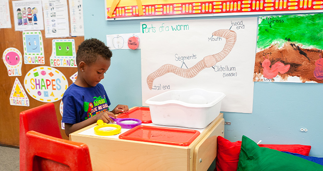 A photo of a child in an early learning classroom