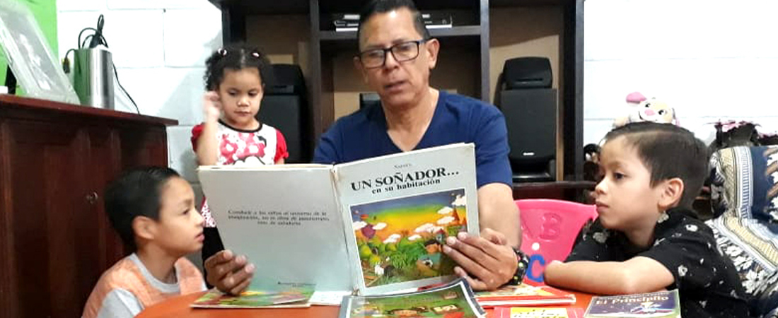 With Schools Closed, Honduran Students Learn at Home A photo of a family reading in Honduras representing With Schools Closed, Honduran Students Learn at Home
