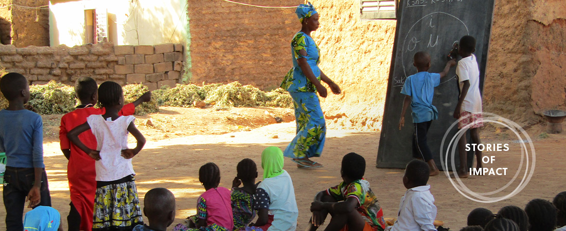 A photo of students and teacher representing Reading Inspires Students, Parents in Mali