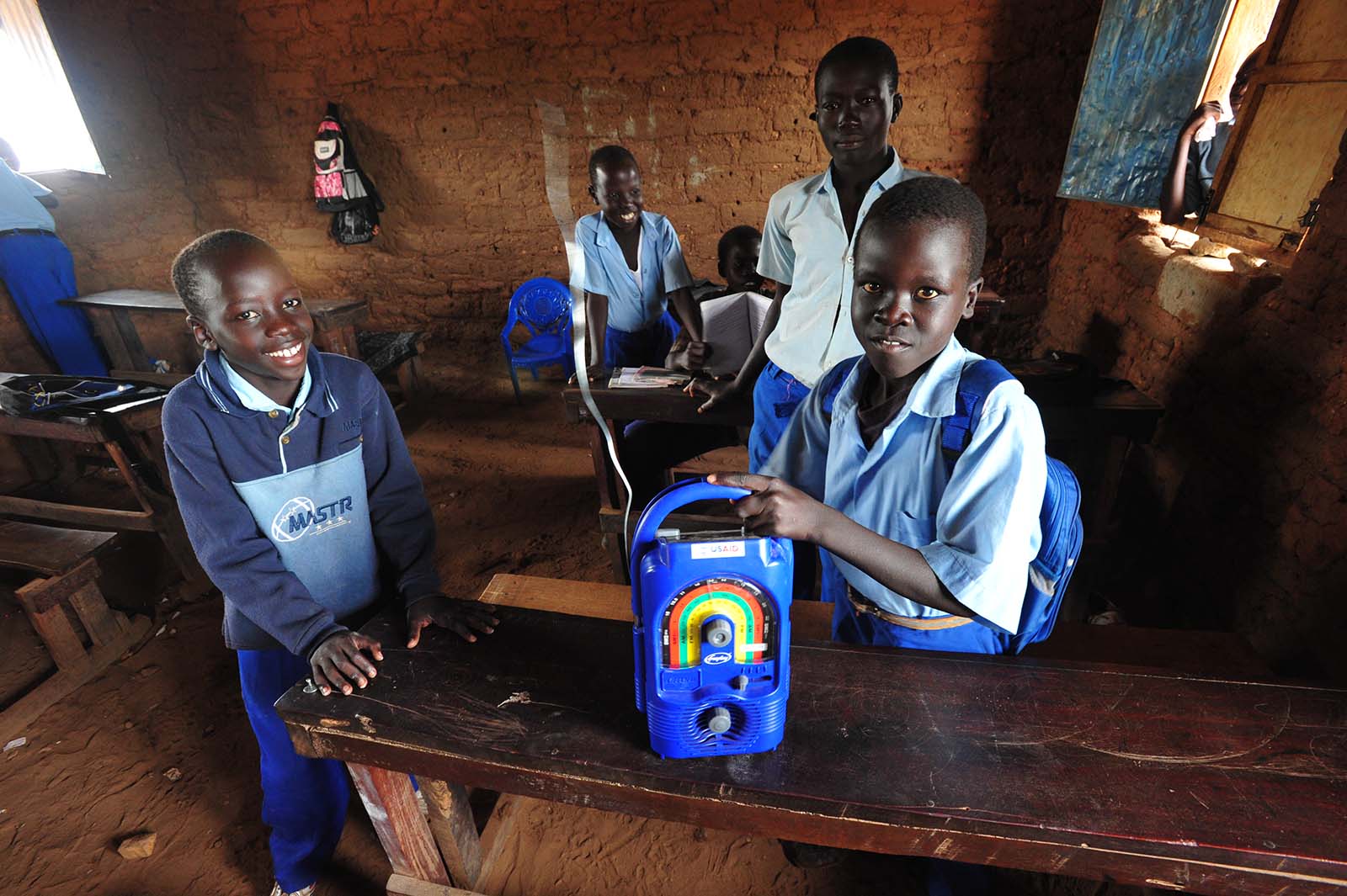 Students in South Sudan listening to an EDC radio program.