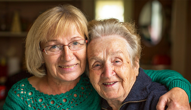 A photo of a woman with her elderly mother. A photo of a woman with her elderly mother.