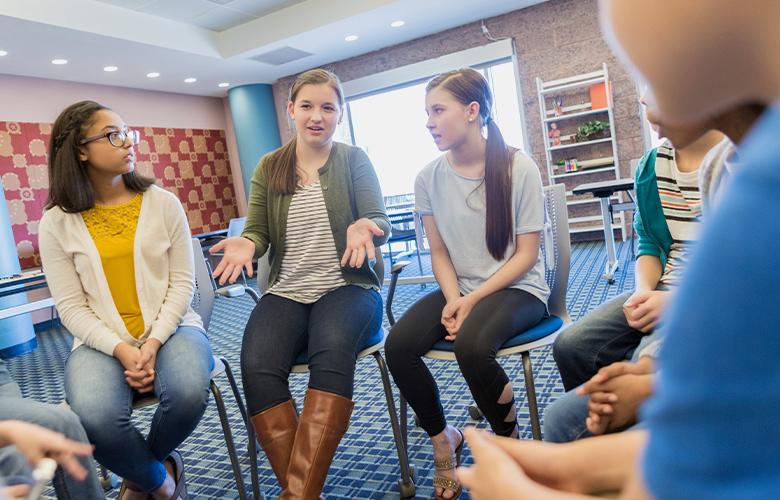 After the Violence—Using SEL to Prepare the Next Generation of Citizens A photo of students having a discussion