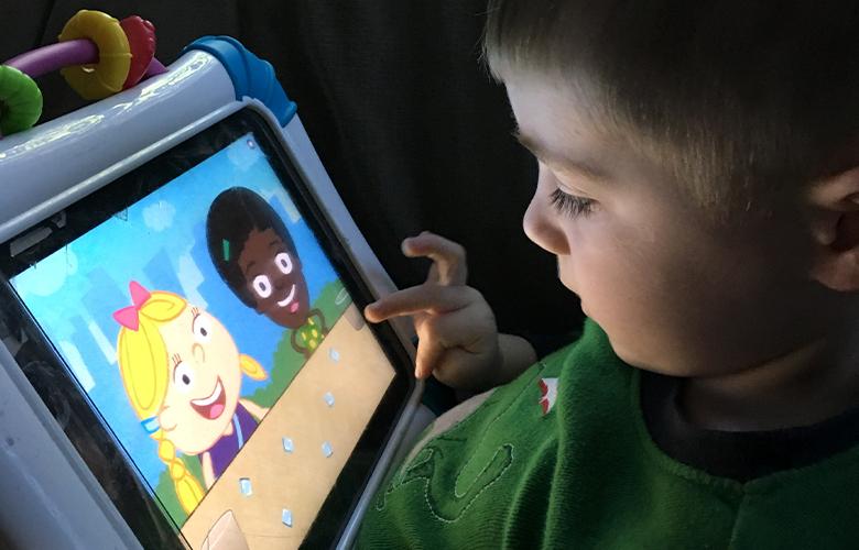 A photo of a child using a tablet