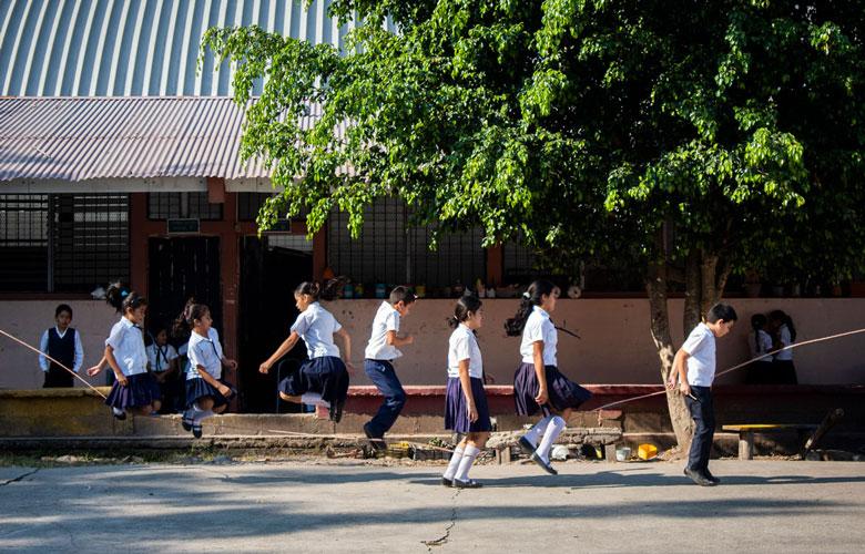 Children playing jump rope in a school yard