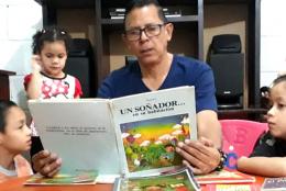 A photo of a family reading in Honduras representing With Schools Closed, Honduran Students Learn at Home