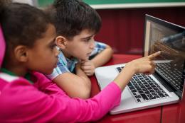 A photo of kids using a computer representing Celebrating Computer Science Education Week