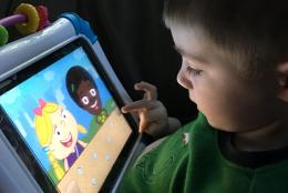 A photo of a child using a tablet